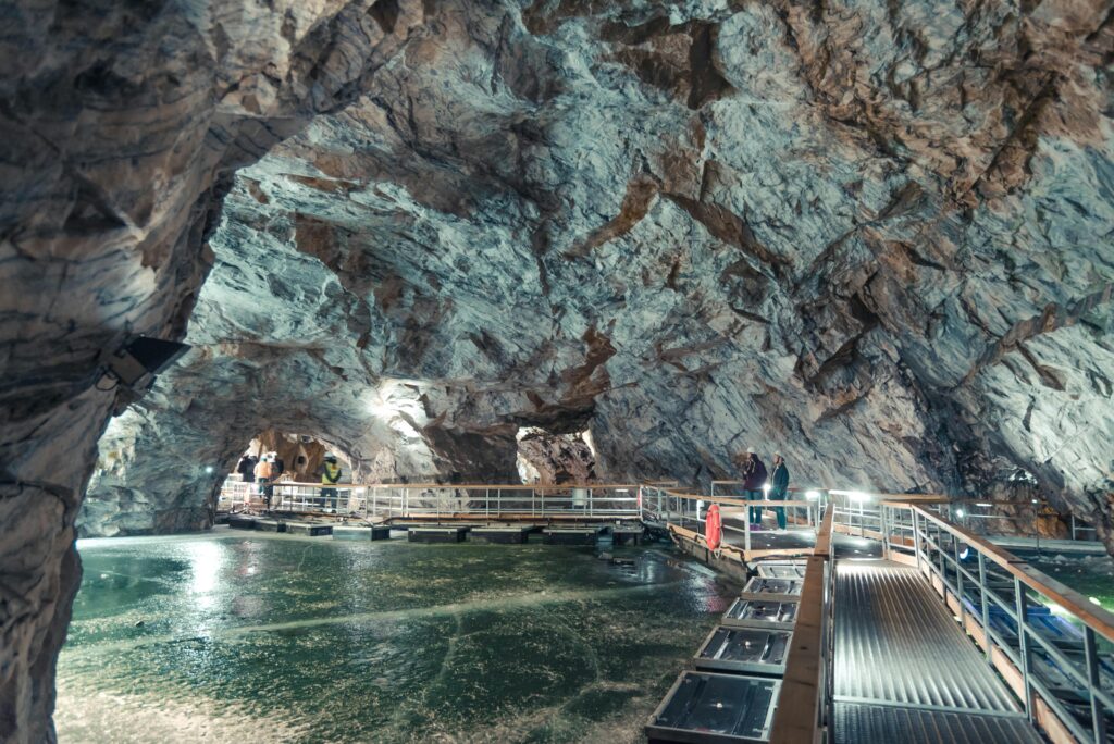 Visitors exploring the stunning marble caves of Ruskeala, Russia.